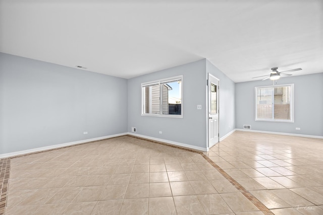 tiled empty room with ceiling fan