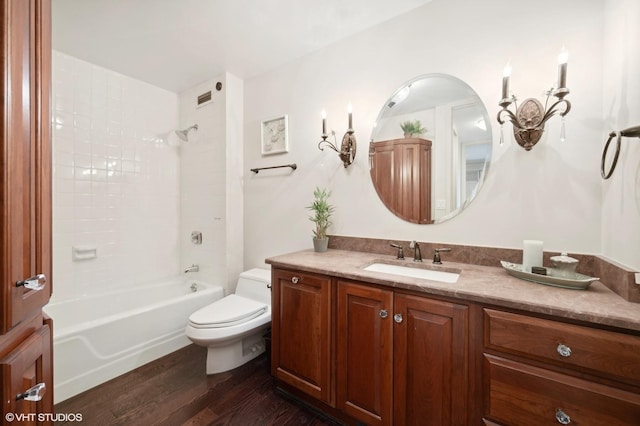 full bathroom featuring hardwood / wood-style flooring, shower / bathing tub combination, toilet, and vanity