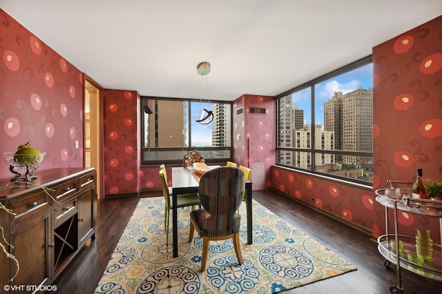 dining room featuring dark hardwood / wood-style floors and floor to ceiling windows