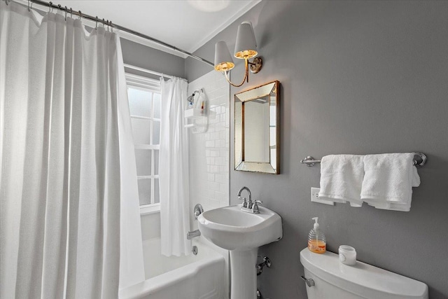 bathroom with shower / bath combination with curtain and toilet