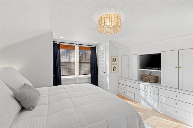 bedroom with crown molding and a textured ceiling