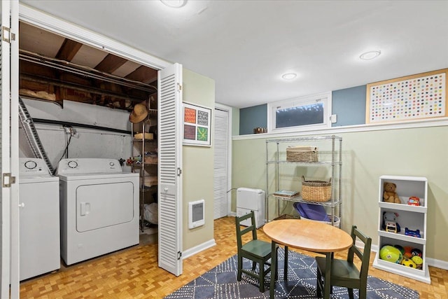 laundry room with light parquet floors and heating unit