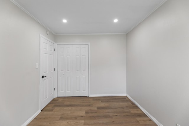 interior space with crown molding, a closet, and dark hardwood / wood-style floors