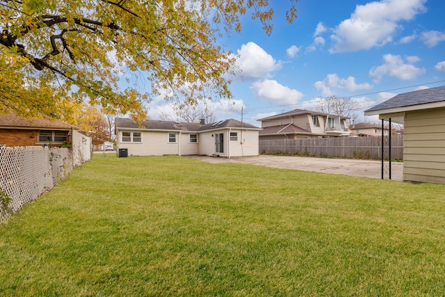 back of house with a patio area and a yard