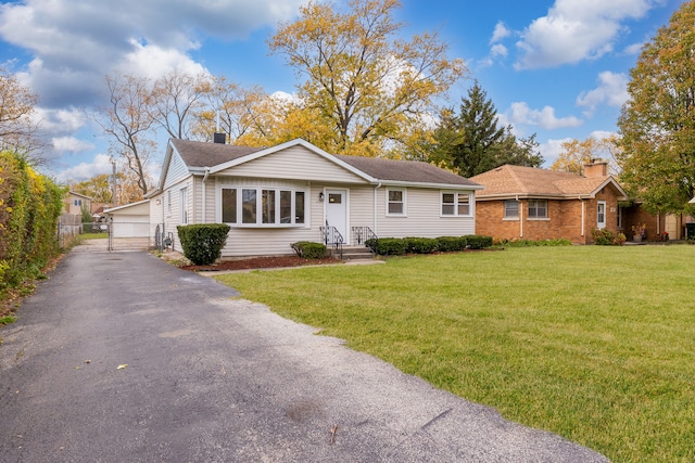 ranch-style home with a garage and a front lawn