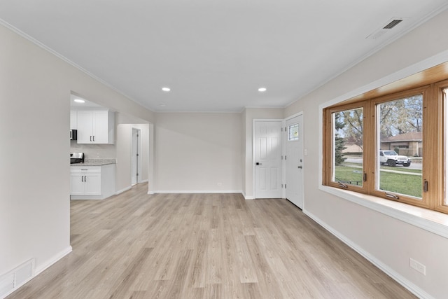 unfurnished living room featuring light hardwood / wood-style flooring and crown molding