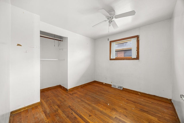 unfurnished bedroom with a closet, ceiling fan, and wood-type flooring