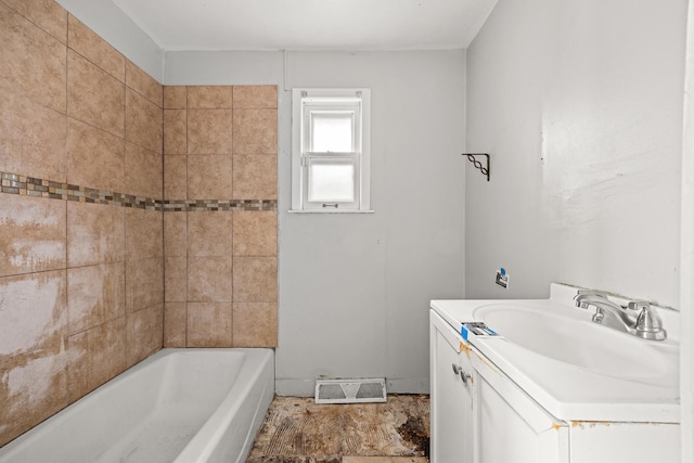 bathroom with vanity and a washtub