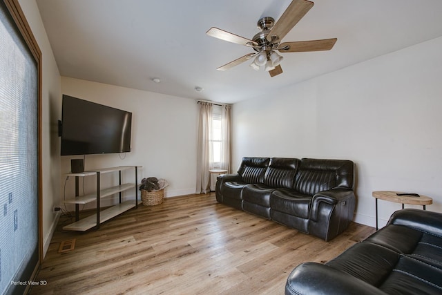 living room featuring ceiling fan and light hardwood / wood-style floors