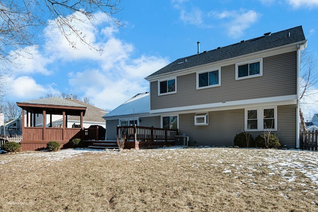 back of house with cooling unit and a deck