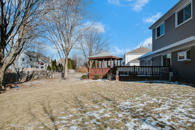 yard layered in snow featuring a gazebo and central air condition unit