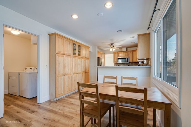 dining space featuring washing machine and dryer, ceiling fan, and light hardwood / wood-style flooring