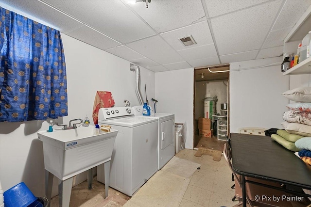 clothes washing area with sink and washing machine and clothes dryer