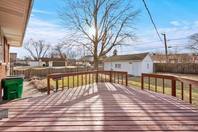 wooden deck with an outbuilding and a lawn