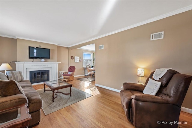 living room featuring crown molding and light wood-type flooring