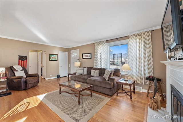 living room featuring crown molding and wood-type flooring