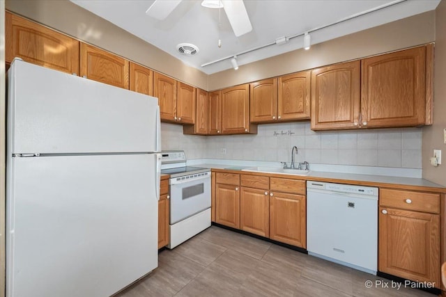 kitchen featuring sink, decorative backsplash, ceiling fan, track lighting, and white appliances