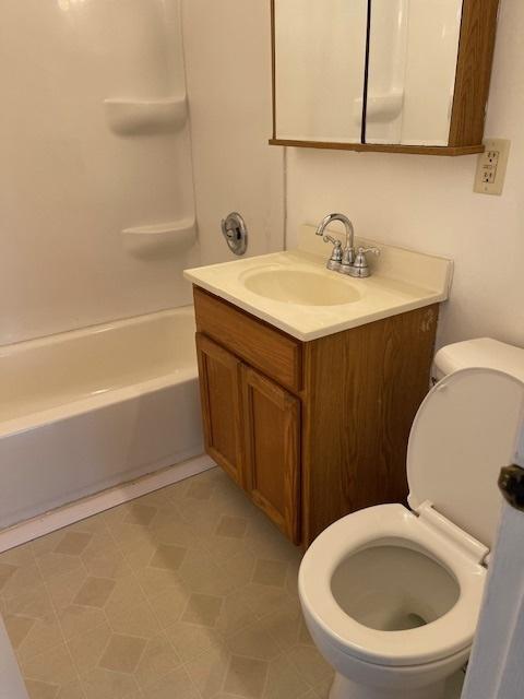 full bathroom with toilet,  shower combination, and vanity