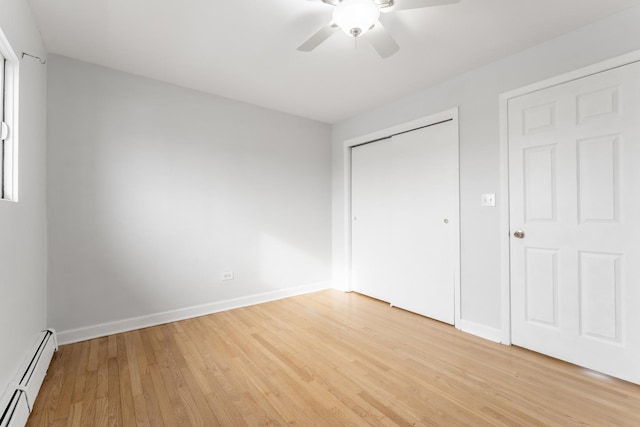 unfurnished bedroom with ceiling fan, a baseboard radiator, and light hardwood / wood-style floors