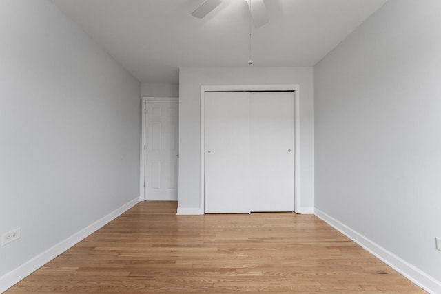 unfurnished bedroom with ceiling fan, light hardwood / wood-style floors, and a closet