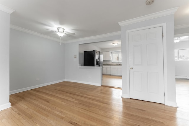 unfurnished living room with crown molding, light hardwood / wood-style flooring, a baseboard radiator, and ceiling fan