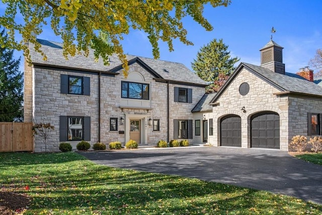 view of front of property featuring a garage and a front yard