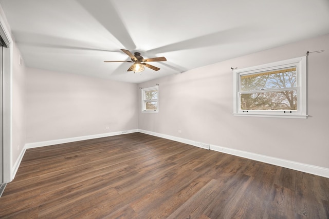 empty room featuring ceiling fan and dark wood-type flooring