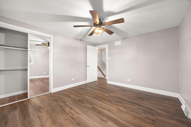 unfurnished bedroom with dark hardwood / wood-style floors, a closet, and ceiling fan