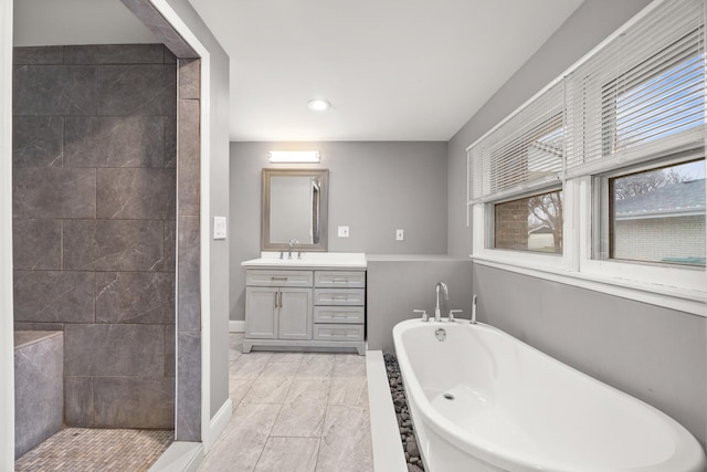 bathroom with tile patterned floors, vanity, and plus walk in shower