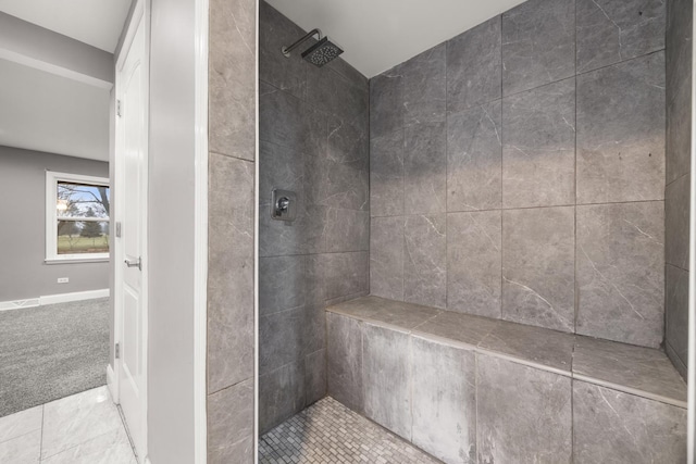 bathroom featuring a tile shower