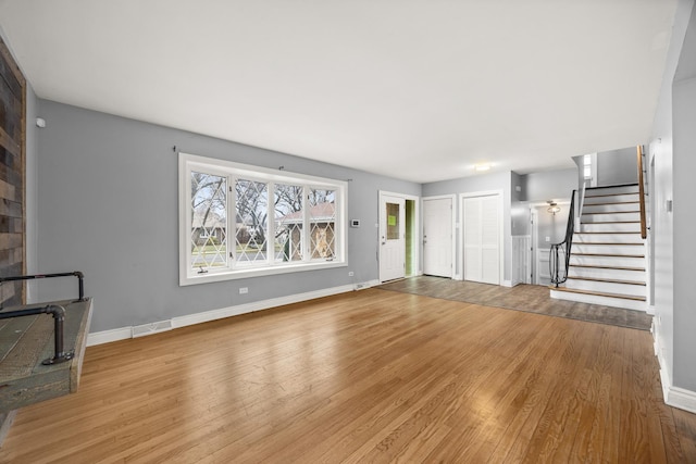 unfurnished living room featuring light wood-type flooring