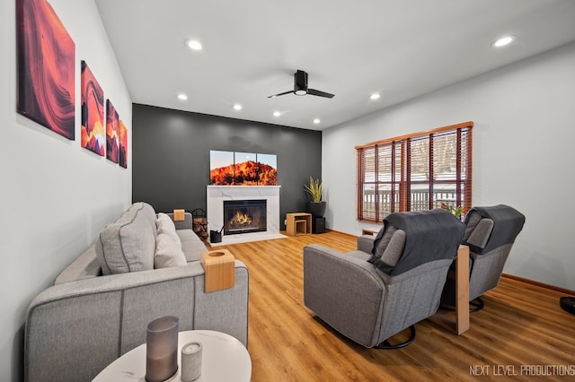 living room featuring wood-type flooring and ceiling fan