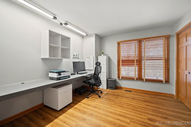 office space with wood-type flooring