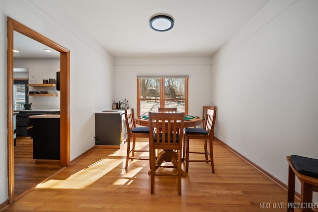 dining space with light wood-type flooring