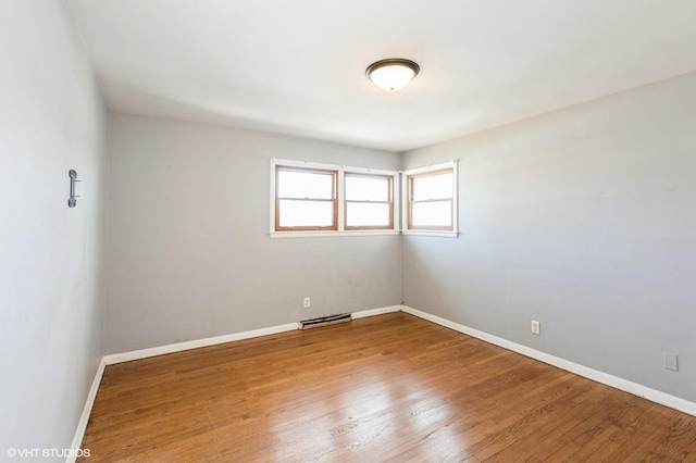 spare room featuring wood-type flooring