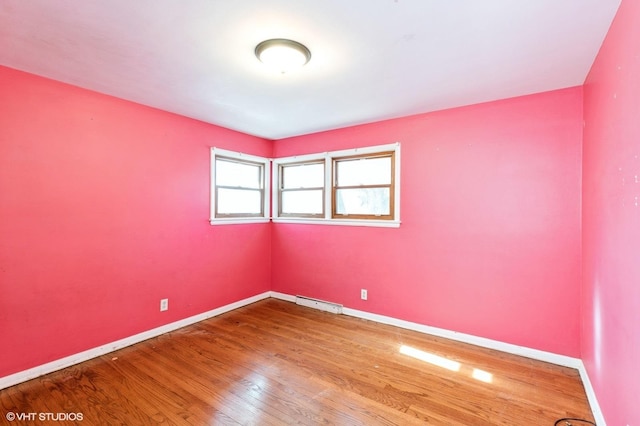 empty room with wood-type flooring