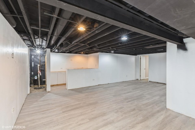 basement featuring light wood-type flooring