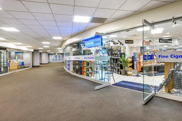 interior space featuring carpet floors and a paneled ceiling