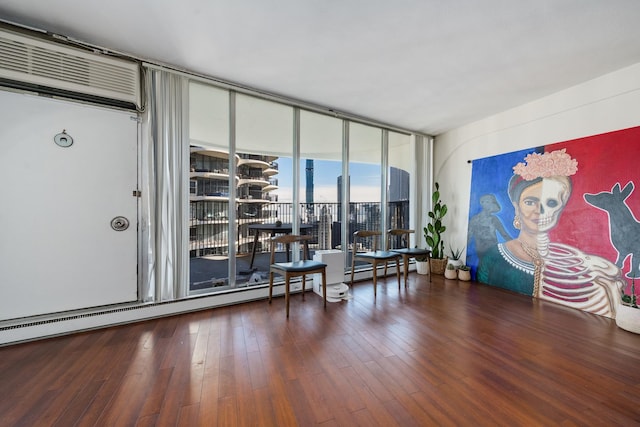 misc room featuring expansive windows, a baseboard radiator, and dark hardwood / wood-style floors