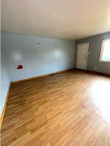 spare room with light hardwood / wood-style flooring