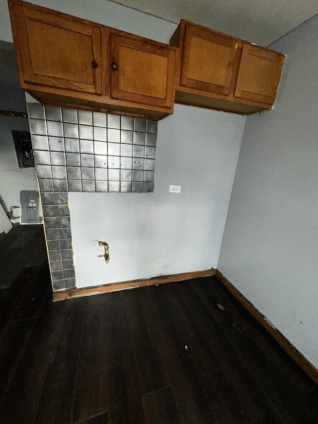 kitchen with dark hardwood / wood-style floors, tasteful backsplash, and mail boxes