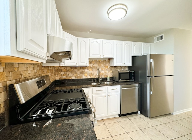 kitchen with light tile patterned flooring, ventilation hood, sink, white cabinets, and stainless steel appliances