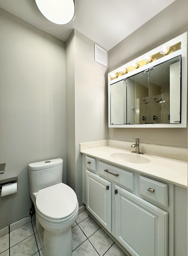 bathroom featuring tile patterned floors, vanity, and toilet