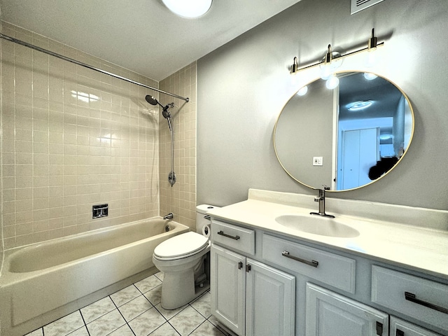 full bathroom featuring vanity, tiled shower / bath, tile patterned flooring, and toilet