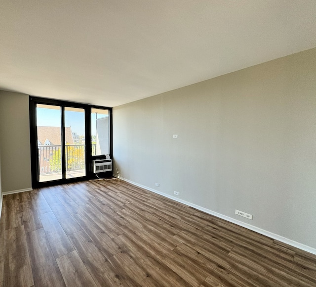 unfurnished room featuring dark hardwood / wood-style flooring and floor to ceiling windows