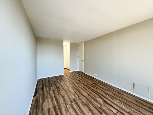 spare room featuring dark hardwood / wood-style floors