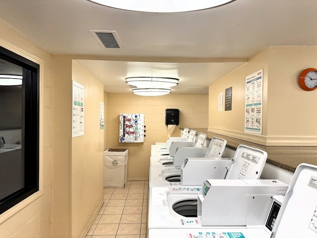 washroom with light tile patterned floors and independent washer and dryer