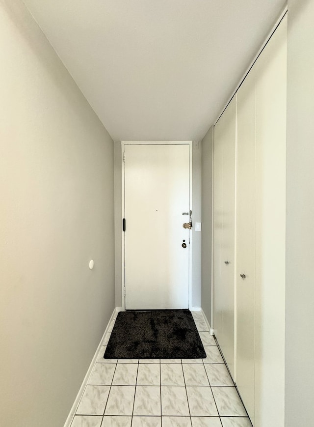 doorway with light tile patterned floors