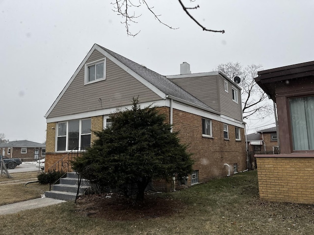 view of side of property with a yard