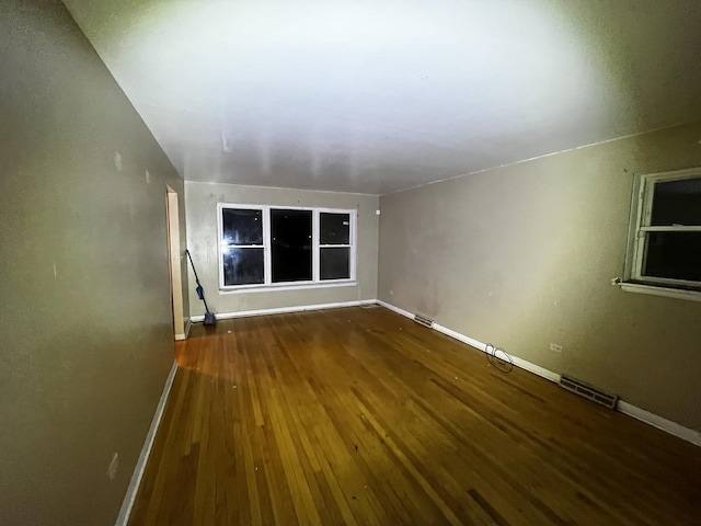 unfurnished room with hardwood / wood-style floors